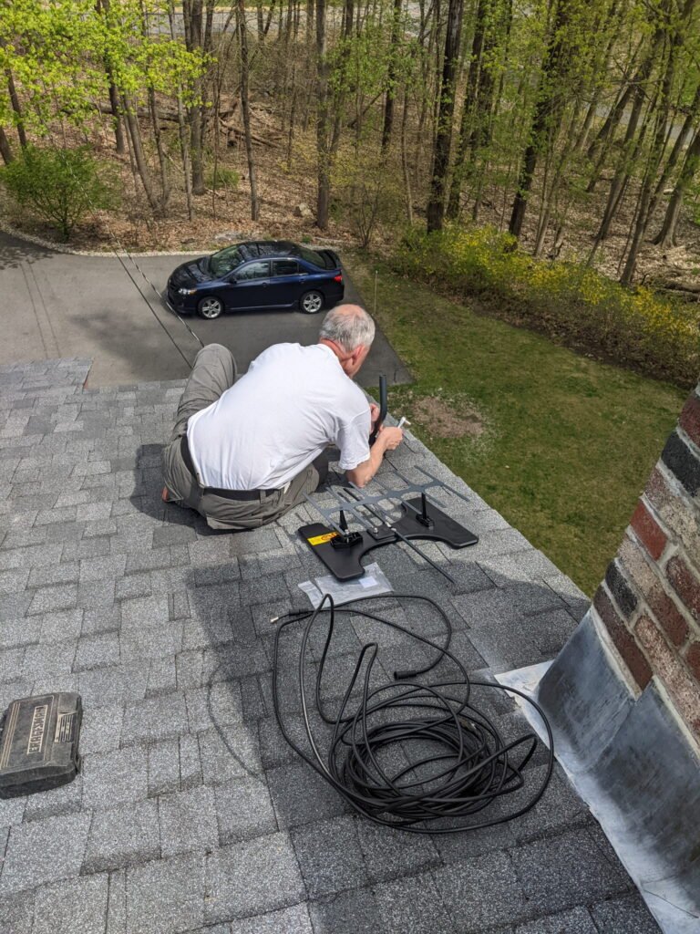 picture of Joe on the roof installing antenna
