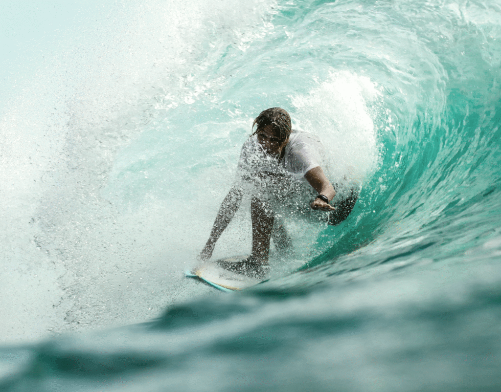 picture of a surfer riding in the tube of a wave.