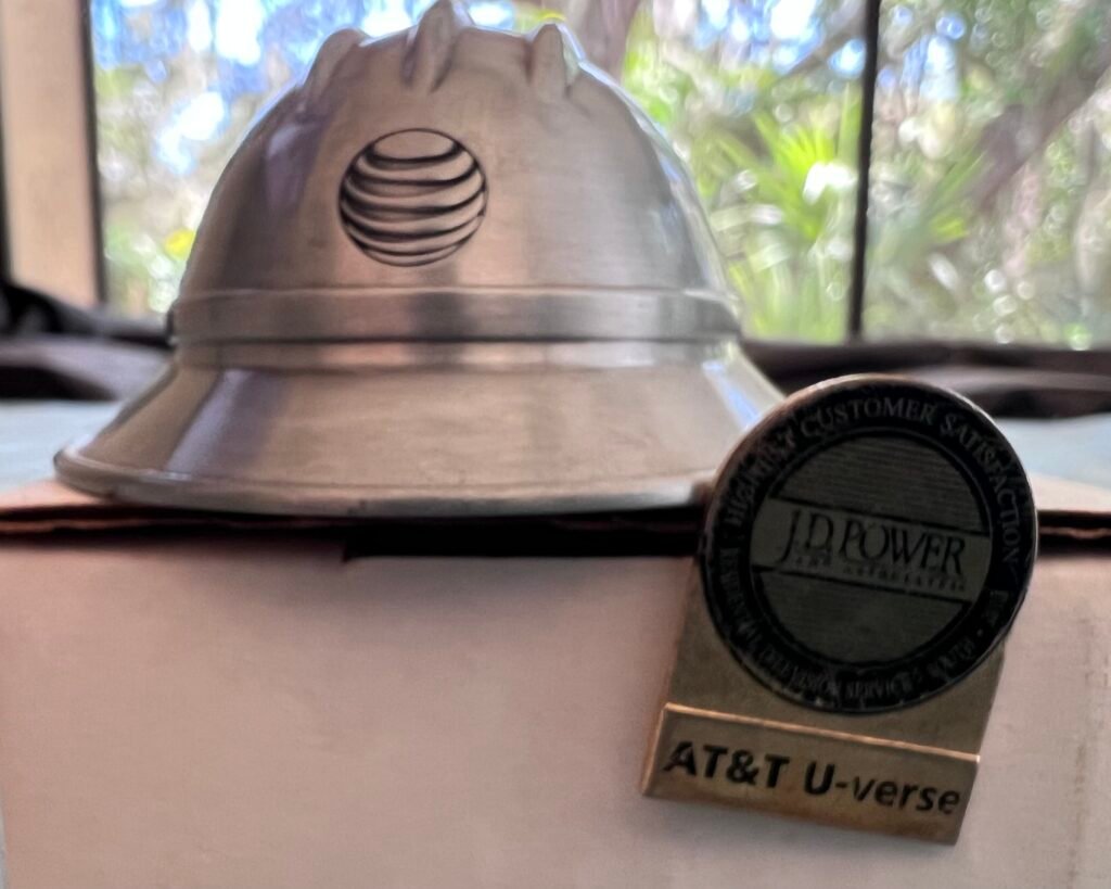 picture of AT&T helmet token and U-verse pin